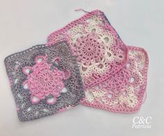 three crocheted coasters are shown on a white surface, one is pink and the other is gray