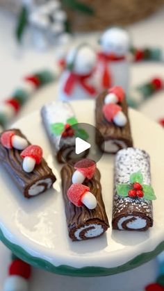 a white plate topped with lots of chocolate covered desserts on top of a table