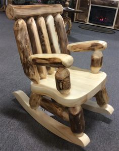 a wooden rocking chair made out of logs