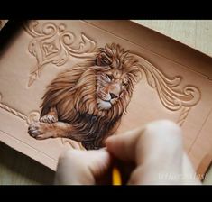 a drawing of a lion on a piece of paper with a pencil in it's hand