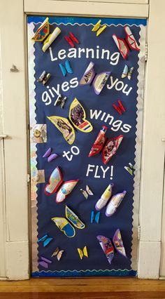 a door decorated with colorful magnets and writing that says learning gives you wings to fly