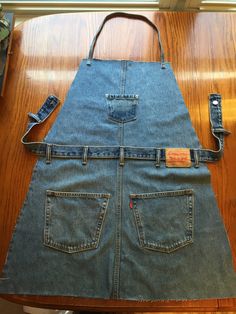 an apron made out of jeans is sitting on a table