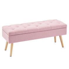 a pink bench with wooden legs and a buttoned up seat on the backrest