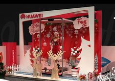 a woman standing in front of a christmas display