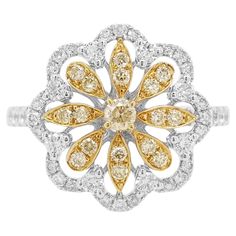 This unique flower shaped ring features natural Yellow diamonds at the heart of the design. The rich colour of these diamonds is complimented perfectly by the delicate platinum floral design which completed by a combination of round brilliant-cut white diamonds. Pair this with your favourite outfit for that final luxurious touch – especially when paired with the matching pendant. - Round Brilliant Cut Yellow Diamonds total 0.20 carat - Round Brilliant Cut White Diamonds total 0.48 carat (color E Luxury White Gold Diamond Ring With Flower Shape, Luxury White Gold Flower Shaped Diamond Ring, White Gold Diamond Ring With Flower Shape, Luxury Flower Shaped Brilliant Cut Diamond Ring, Luxury White Flower-shaped Diamond Ring, White Diamond Flower Ring With Prong Setting, White Diamond Ring With Rose Cut Flower Shape, Diamond White Flower-shaped Ring With Diamond Accents, White Diamond Flower-shaped Ring With Accents