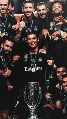 the real madrid players are posing with the trophy