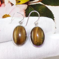 Tiger's Eye Earrings, Tiger's Eye Jewelry, Officewear Earrings, 925 Sterling Silver Earrings, Christams Gift Earrings, Gift For Her, D1219 This is a high quality handmade 925 Sterling Silver Jewelry. The piece is ready to ship and you will get the exact same piece as shown in photo. Stone name:  Tiger's Eye Stone Color: Yellow Stone quality and origin: Dominican republic - AAA - natural Weight:    7.7Grams Stone Size- 13x18mm Metal: Sterling Silver Purity of Silver: 92.5% Each jewelry piece is nicely packed and sent into post. Worldwide shipping from Canada. The beautiful 925 Sterling Silver and natural gemstone jewelry is brought to you by Shalzcrystals Classic Brown Jewelry With Matching Earrings, Brown Oval Earrings As A Gift, Brown Oval Earrings For Gift, Brown Oval Earrings Gift, Hypoallergenic Brown Sterling Silver Earrings, Classic Brown Round Earrings, Formal Brown Sterling Silver Earrings, Brown Sterling Silver Drop Earrings, Tigers Eye Jewelry