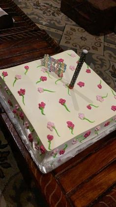 a square cake with pink flowers on it