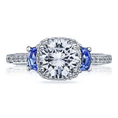 a diamond and blue sapphire engagement ring with diamonds on the sides, set in white gold