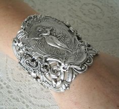 "This beautiful silver plated cuff bracelet has a silver plated art nouveau maiden, silver plated chain and lobster clasp. 2.75\" at the widest part. Adjustable." Victorian Bracelet, Plate Art, Art Nouveau Jewelry, S Tattoo, Silver Cuff Bracelet, Silver Cuff, Silver Bracelets, Cuff Bracelet, Silver Plate