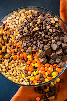 a bowl filled with candy corn and chocolate chips