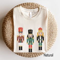 Nutcracker Trio Tee is perfect for ballet lovers or anyone looking for a classic holiday design! Match up with the kids for a great photo or matching pajama tops! YOUTH Sizes Here: https://www.etsy.com/listing/1296554965/kids-christmas-shirts-nutcracker-tee TODDLER Sizes Here: https://www.etsy.com/listing/1296555543/toddler-christmas-shirts-nutcracker-tee Looking for more Christmas and Winter themed apparel? Check these out: https://www.etsy.com/shop/TheGraphicPeach?ref=seller-platform-mcnav§ion Group Christmas Shirts, Ballet Christmas, Toddler Christmas Shirt, Fiesta Shirt, Matching Pajama, Christmas Shirts For Kids, Christmas Party Shirts, Christmas And Winter, Kids Tshirt