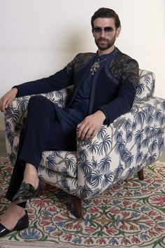 Navy blue bandhgala with placement hand embroidery, accentuated with golden stud work. Paired with an inner kurta and straight pant. - Aza Fashions Fitted Hand Embellished Sets For Festivals, Fitted Hand-embellished Sets For Festivals, Hand Embellished Fitted Sets For Festivals, Hand Embellished Fitted Festival Sets, Fitted Sherwani For Navratri Party, Traditional Designer Sherwani Hand Embellished, Traditional Hand Embellished Designer Sherwani, Formal Fitted Bandhgala For Navratri, Bollywood Style Blue Bandhgala For Reception