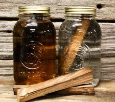 two jars filled with honey and cinnamon sticks