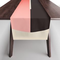 the table is covered with a multicolored rectangular table runner that matches the rest of the table