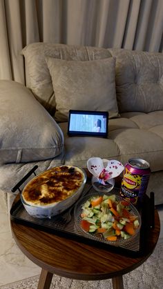 a tray with food on top of it next to a couch