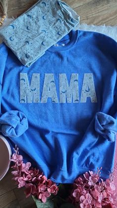 This MAMA sweatshirts is personalized with the clothes of your little one(s  It can be customized to change the name from Nana to any special way the little ones call them like Grandma, Grammy, Mamie, Memaw, Oma and more with the fabric that YOU choose!! You choose what clothing piece you want for each letters.  The fabric is interface to a bonding interfacing and then blanket stitch with a regular sewing machine onto the sweater  These sweatshirts are very comfy and cozy and do RUN BIG, just ke Customizable Family Matching Crew Neck Sweatshirt, Customizable Family Matching Cotton Sweatshirt, Blue Custom Print Top For Mother's Day, Personalized Blue Cotton Tops, Blue Long Sleeve T-shirt For Gift, Blue Long Sleeve T-shirt As Gift, Mother's Day Custom Print Crew Neck Sweatshirt, Blue Crew Neck Sweatshirt With Name Print, Baby Clothes Keepsake