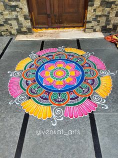 a colorful design on the ground in front of a door