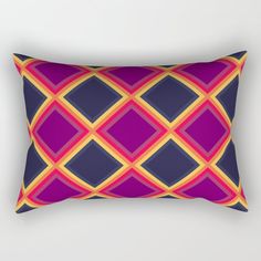 a purple and yellow rectangular pillow on a white wall