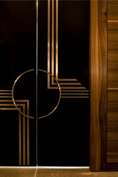 a black and gold door with an abstract design