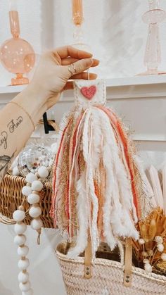 a person holding a basket with some items in it and an object hanging from the handle