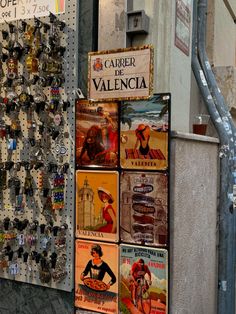 several magnets are attached to the wall in front of a storefront with an advertisement on it