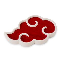 a red and white cloud shaped dish on a white surface with swirls in the middle