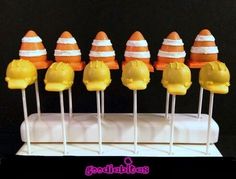 there are many yellow and orange marshmallows with hats on them for halloween