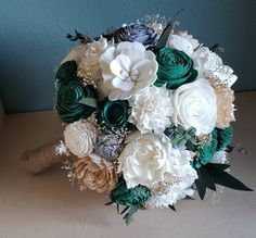 a bridal bouquet with green and white flowers