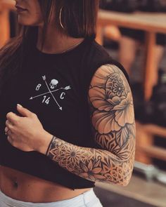 a woman with tattoos on her arms and shoulder