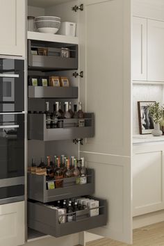 an open cabinet in a kitchen with spices and condiments on the bottom shelf