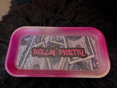 a plastic container filled with money and the words rollin'pretty written on it