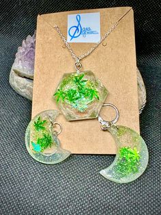 "This one-of-a-kind jewelry set is going to light up every stoner/hippie/festival-goer on your list this year! Each piece was created in Gilbert, AZ and filled with a delightful mix of pot leaf themed glitter before being assembled on sterling silver plated 22\" chain and stainless steel hinged hoops." Mystical Green Jewelry For Gift, Mystical Green Jewelry As Gift, Handmade Magical Style Green Jewelry, Handmade Magical Green Jewelry, Silver Spiritual Plug Earrings For Festivals, Nickel-free Green Jewelry For Festivals, Hippie Green Festival Jewelry, Green Hippie Festival Jewelry, Handmade Green Plug Earrings As Gift