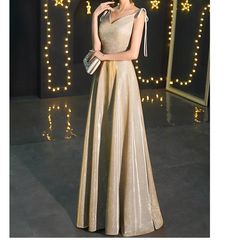 Gold V-neck Evening Dress With Sweep Train, Champagne Evening Dress For Gala Holiday, Champagne Holiday Evening Dress For Gala, Elegant Gold Holiday Dress, Champagne V-neck Evening Gown, Glamorous Gold Gown For Gala, Elegant Gold V-neck Maxi Dress, Elegant Gold V-neck Evening Dress, Gold V-neck Evening Dress For Gala