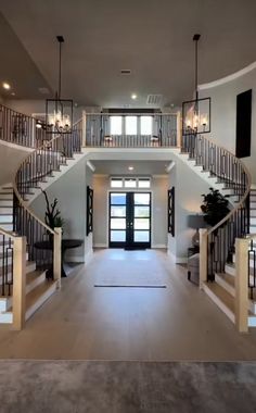 a large open floor plan with stairs leading up to the front door and entryway