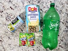 an assortment of drinks and snacks on a granite counter top, including pineapple juice