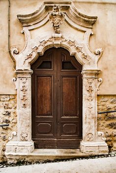 an old building with two wooden doors