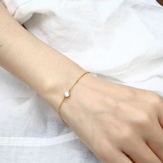 Embrace understated elegance with our "Kendall Bracelet." This delicate and dainty piece features a single diamond on a slender chain, exuding a timeless beauty that is both pretty and refined. Perfect for everyday wear or special occasions, this bracelet effortlessly adds a touch of subtle sparkle and sophistication to any outfit. Nickel, lead, alloy, brass free Hypoallergenic Waterproof Anti-tarnish 10 inches Jewelry Care Sterling Silver To make the most out of your newest addition, we recomme Elegant Everyday Hypoallergenic Jewelry, Adjustable Diamond Bracelet With Delicate Chain, Elegant Round Diamond Bracelet, Tarnish Resistant, Elegant Round Tarnish Resistant Diamond Bracelet, Elegant Round Tarnish-resistant Diamond Bracelet, Elegant Sterling Silver Gold Bracelet, Tarnish Resistant, Dainty Cubic Zirconia Formal Bracelets, Dainty Adjustable Diamond Chain Bracelet, Dainty White Gold Chain Bracelet, Tarnish Resistant