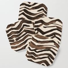 four zebra print coasters sitting on top of each other