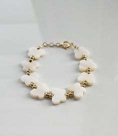 This is by far a Summer favorite for all the Lil' Babes! Crafted with 14K Gold plated beads and a secure gold-filled clasp, paired with adorable white butterflies. This combo of elegance and whimsical wonder is the perfect accessory for those tiny little wrists.  THERE ARE NO RETURNS OR EXCHANGES FOR WRONG SIZE. To ensure proper sizing, please measure your baby's wrist before you purchase. Use a soft measuring tape tightly and add 1/2" to find the correct size.  WARNING: CHOKING HAZARD Never leave a child unattended with a bracelet on. White 14k Gold Pearl Bracelet Gift, White 14k Gold Pearl Bracelet As Gift, White Butterflies, Stocking Stuffers For Girls, Baby Blessing, Baby Girl Shower Gifts, Butterfly Baby, Baby Bracelet, Butterfly Bracelet