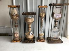 three hourglasses with different types of bottles in them