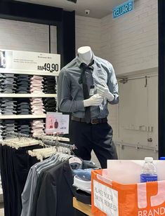 a store display with mannequins and shirts for sale