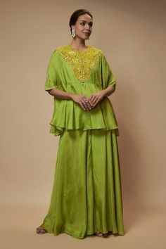 Green peplum tunic embellished by sequin bead floral motifs on yoke. Comes with sequined palazzo and slip - Aza Fashions Sequin Tunic, Green Tunic, Tunic Pattern, Beaded Neckline, Floral Peplum, Cape Sleeves, Indian Fashion Dresses, Sequin Beading, Floral Motifs