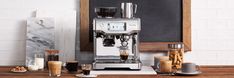 an espresso machine sitting on top of a wooden table