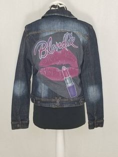 "Blondie women's upcycled denim jacket, junior's size large from Makers of the True Originals. One way or another you'll rock this upcycled Blondie jacket! Features a logo t-shirt with a fun design that has been transformed into a patch sewn on the back. Great for any fan of this new wave rock band! Size runs small. See measurements for proper fit. Bust: 38\" Armpit to Armpit: 19\" Down the back: 20\"  Shoulder seam to shoulder seam: 15\" Shoulder seam to end of cuff: 25\" Condition: Pre-owned - Casual Upcycled Denim Outerwear, Fitted Denim Jacket With Graphic Print In Medium Wash, Reworked Medium Wash Denim Jacket For Fall, Upcycled Long Sleeve Denim Jacket For Spring, Spring Upcycled Long Sleeve Denim Jacket, Fall Reworked Medium Wash Denim Jacket, Fitted Winter Denim Jacket With Graphic Print, Fitted Denim Jacket With Graphic Print For Winter, Casual Reworked Denim Jacket