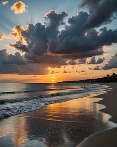 the sun is setting over the ocean with clouds in the sky and water on the beach