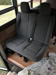 the interior of a camper with two seats up