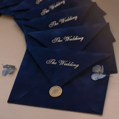 six blue envelopes with the words the wedding written on them