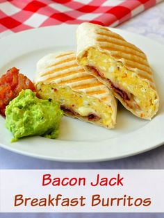 bacon jack breakfast burritos on a plate with guacamole and tomatoes