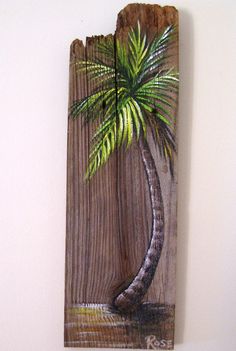 a palm tree is painted on a piece of wood